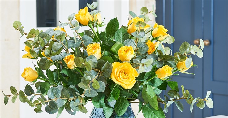 fresh and faux roses arranged in vase