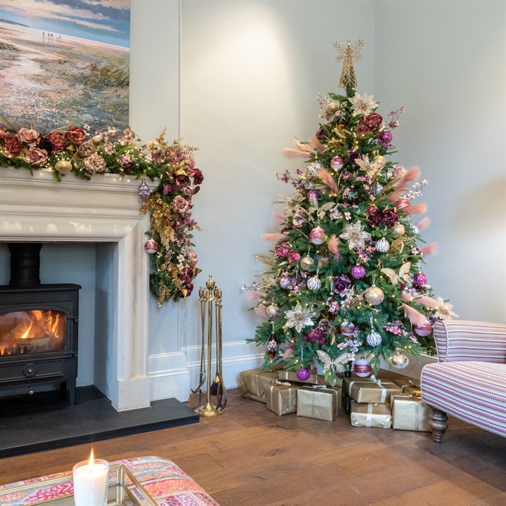 matching pink, purple and gold christmas tree and garland over fireplace in living room