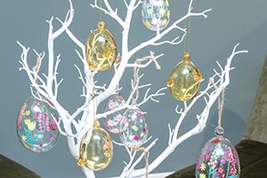 glass easter egg hangers on white twig tree