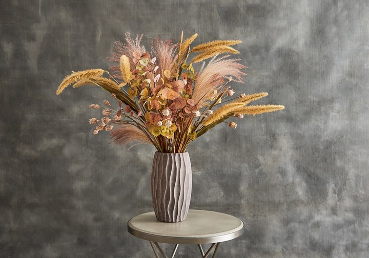 autumnal artificial reeds, grasses, eucalyptus and poppy heads in vase
