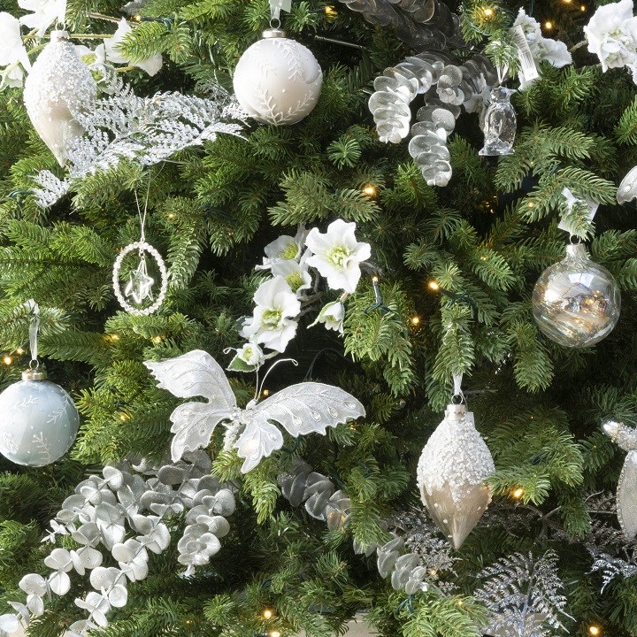 white and silver christmas decorations on tree