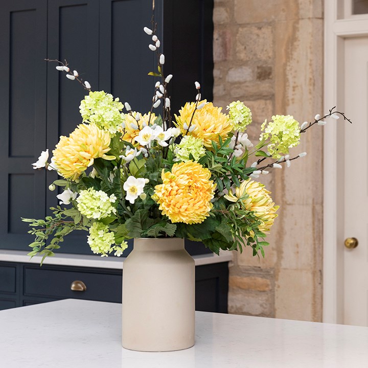 springtime faux flower arrangement in green and yellow