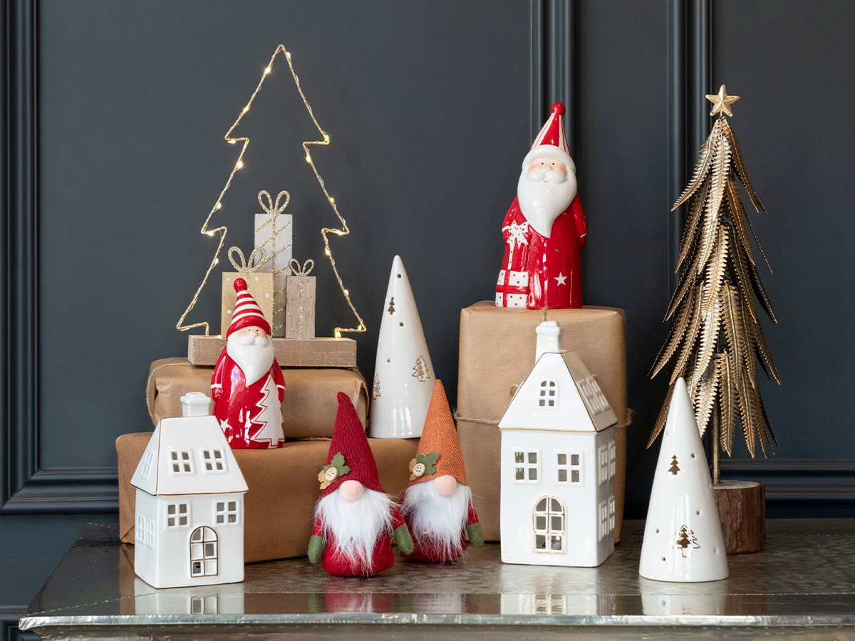 ceramic santas, LED houses and other christmas decorations on tabletop