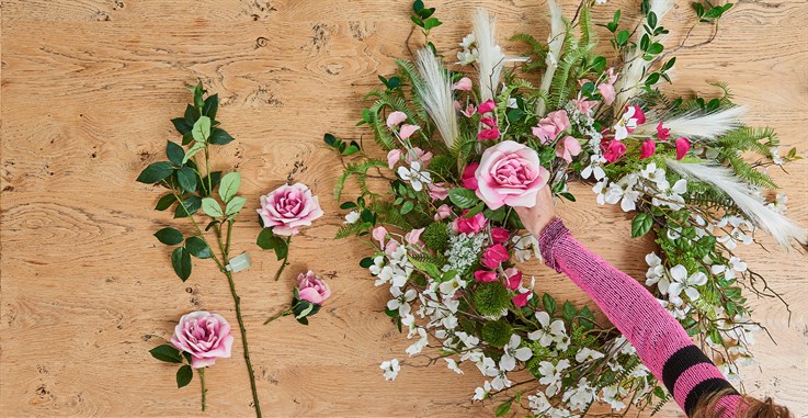 diy floral garland being put together with artificial floral and foliage stems