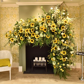 artificial sunflowers displayed over fireplace