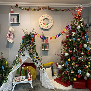 colourful christmas tree display with wreath and tent