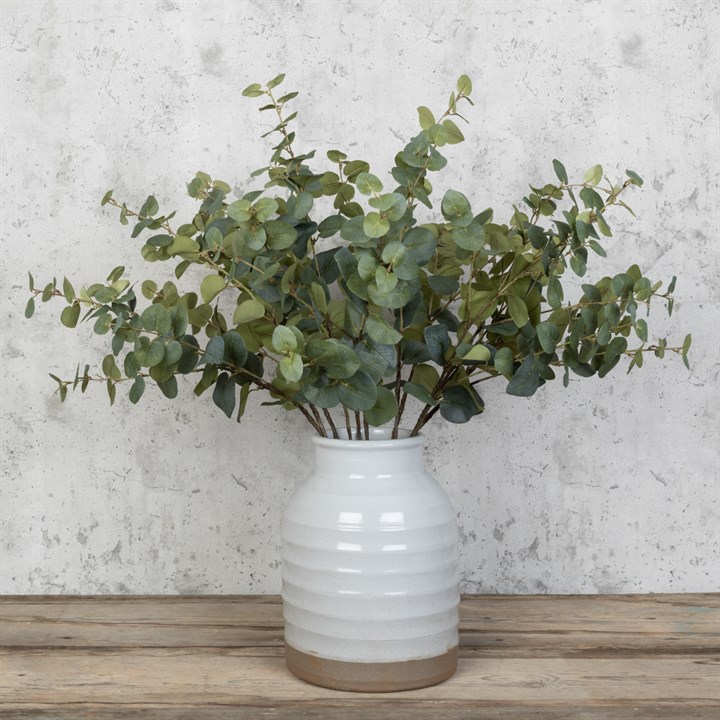 A vase full of green classic faux eucaluptus