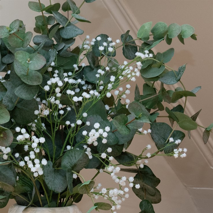 A closer view of the Eucalyptus & Gypsophila Faux Flower Bouquet, where you can better see the pops of white that the gyp provides against the green foliage of the eucalyptus