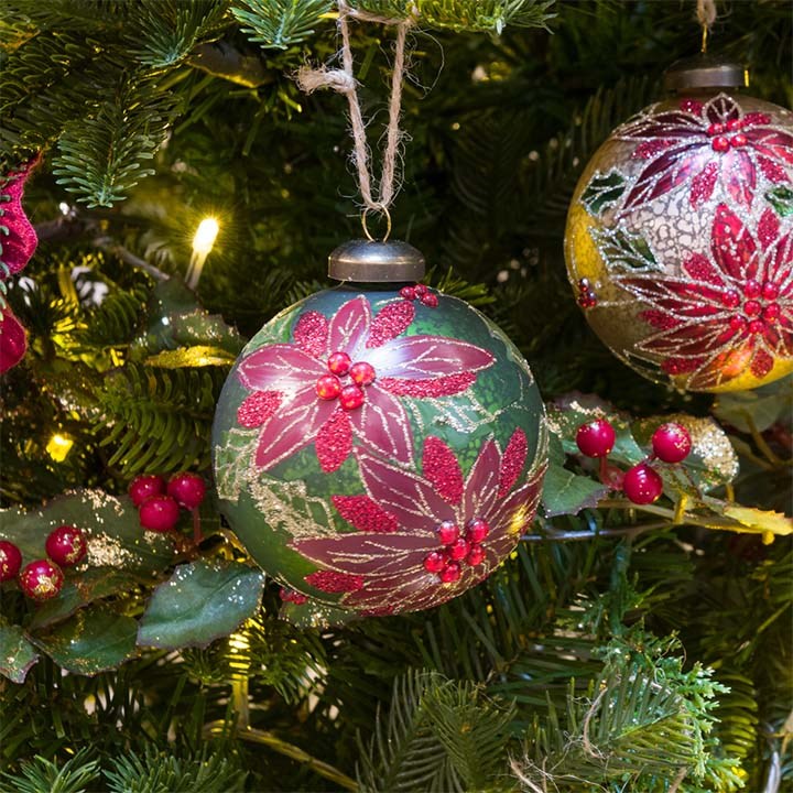 Green and red christmas bauble on tree