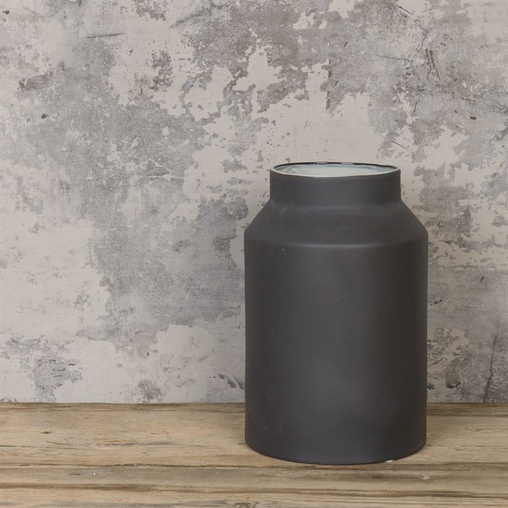 black churn vase on white background