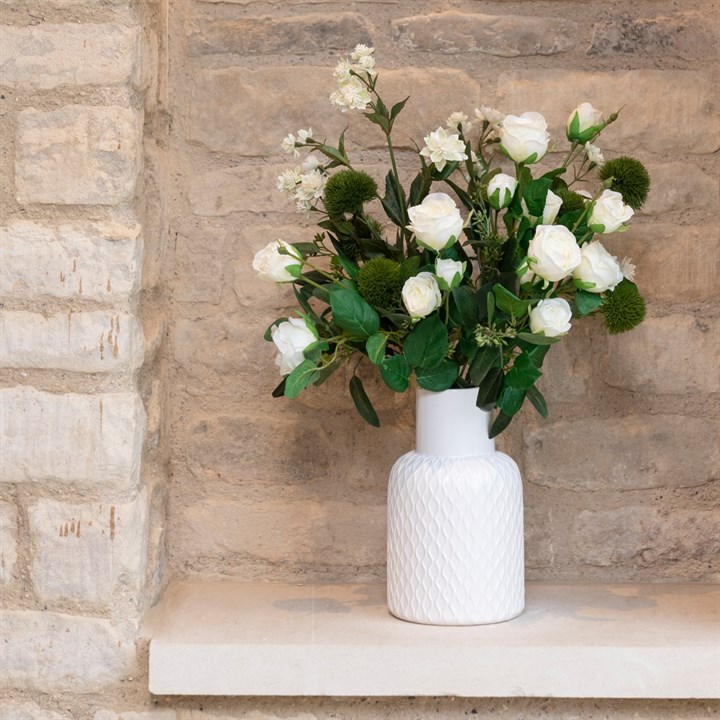 white artificial roses in white vase
