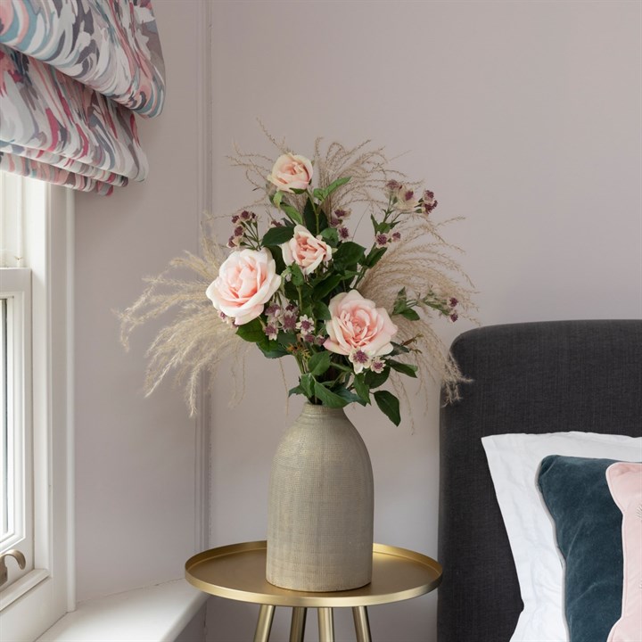 pink faux roses and foliage in vase