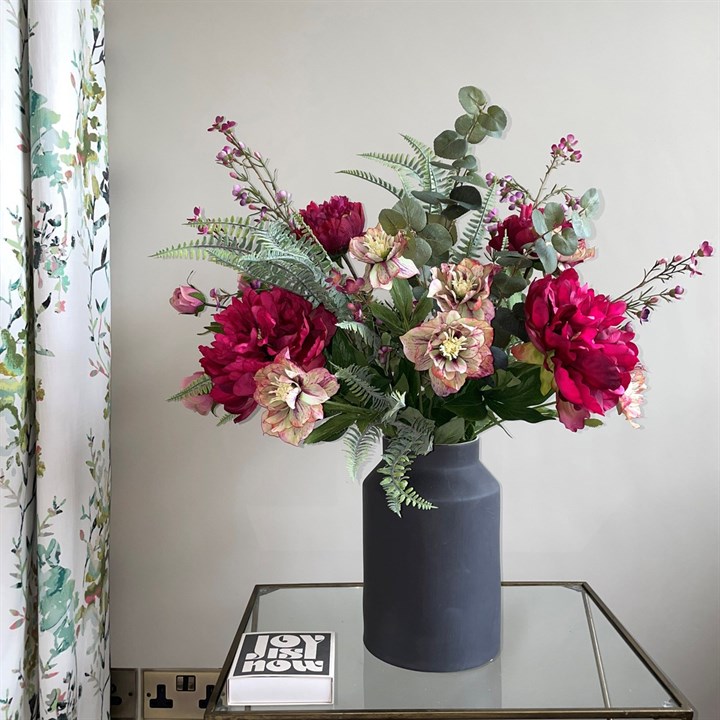 artificail peony, hellebore and foliage arranged in black churn vase