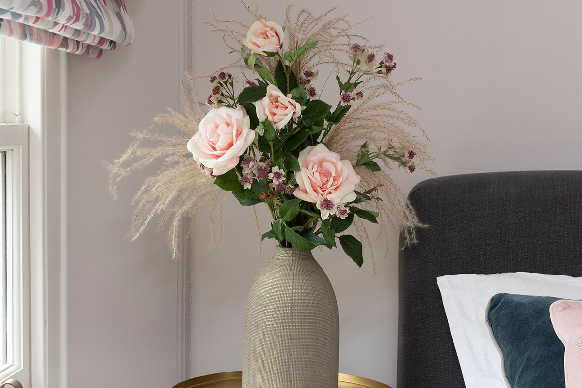 artificial rose and astrantia arranged in vase
