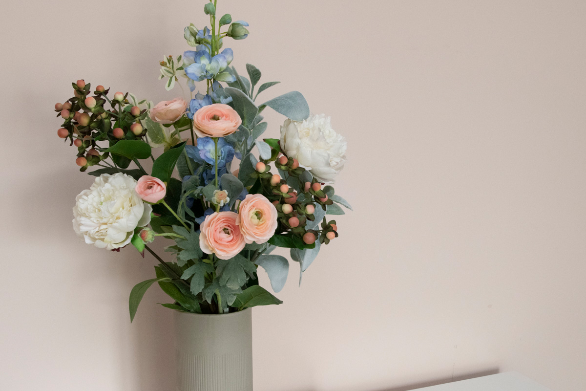 blue, white and peach flowers arranged in vase