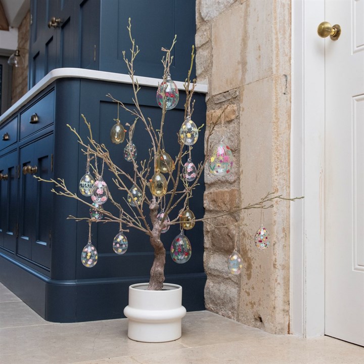 Faux Easter twig tree in pot with hanging decorations